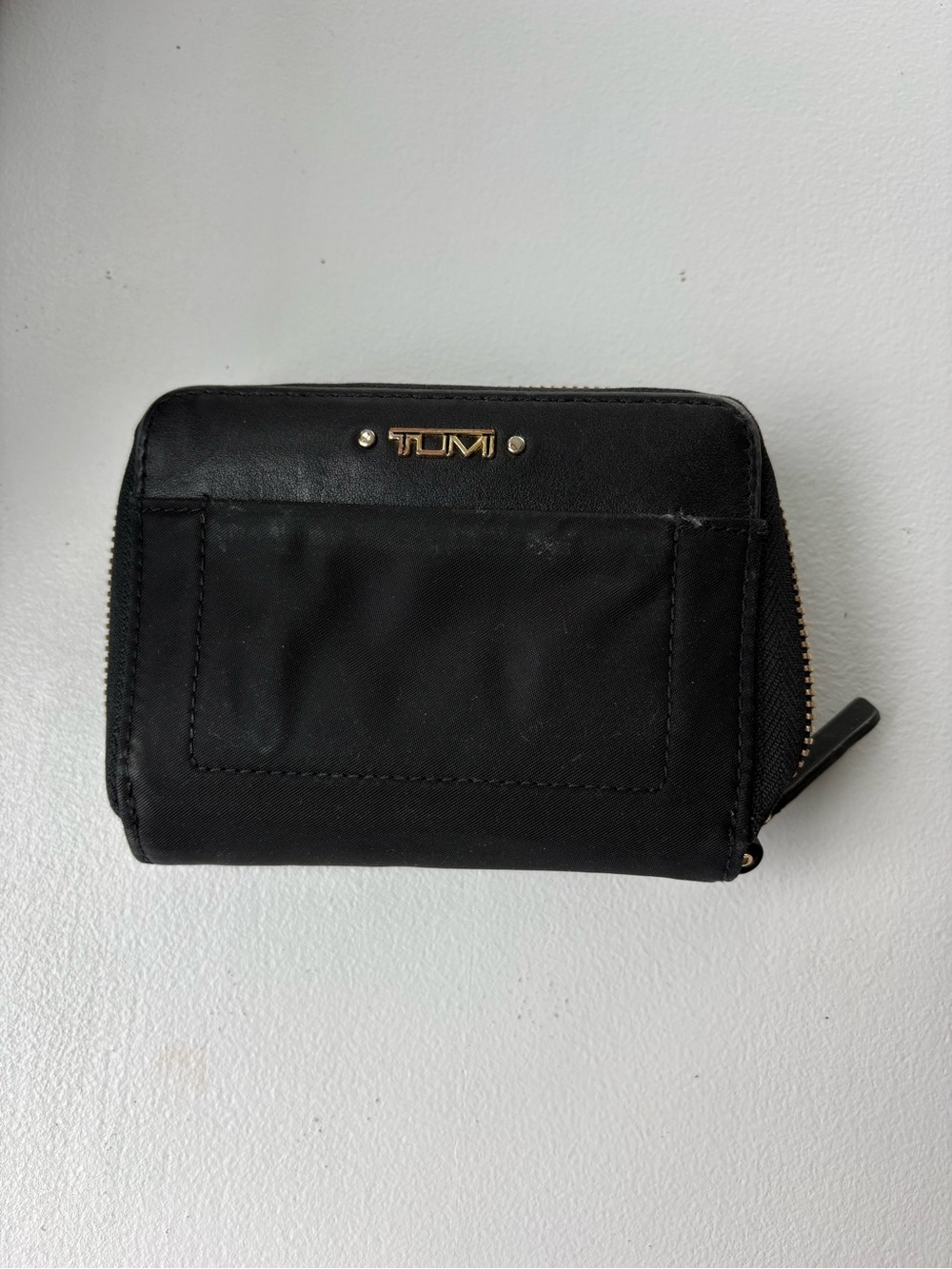Tumi Black Compact Zip-Around Wallet with Gold Logo Plate